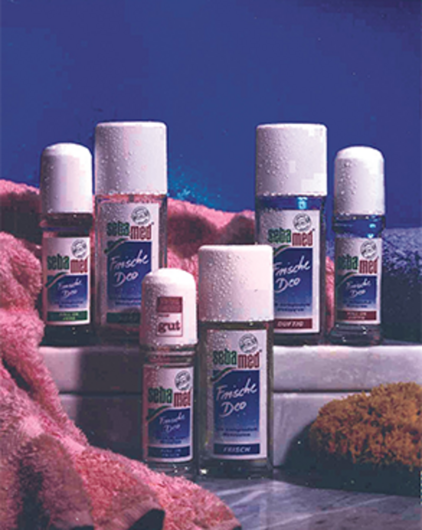 Sebamed Frische Deo roll-on products on a blue surface, advertisement.