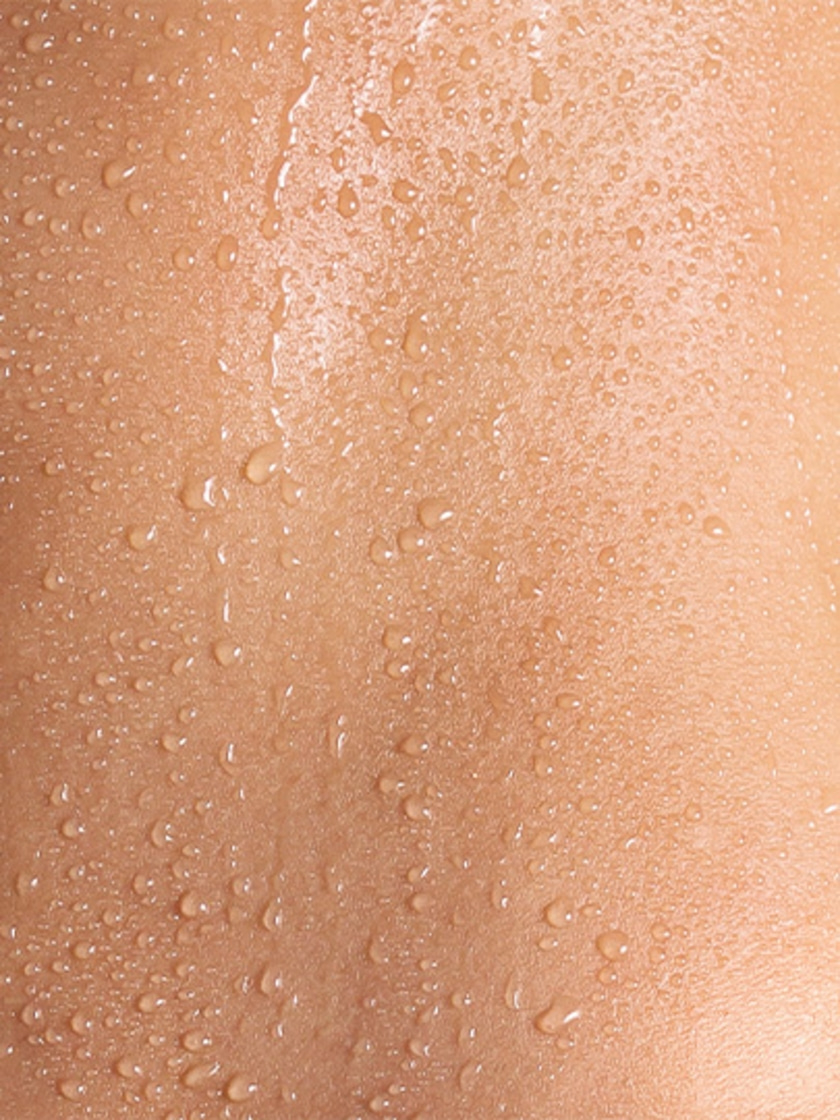 Skin with water droplets, wet and shiny, close-up, texture detail