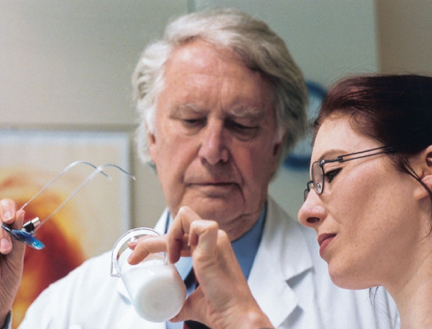 Two scientists examining a liquid in a lab. Research and science.