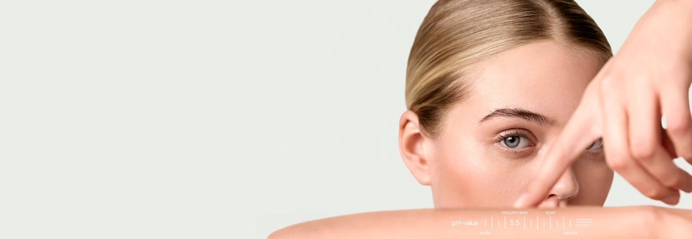 Close-up of a woman with a pH value chart on her skin.