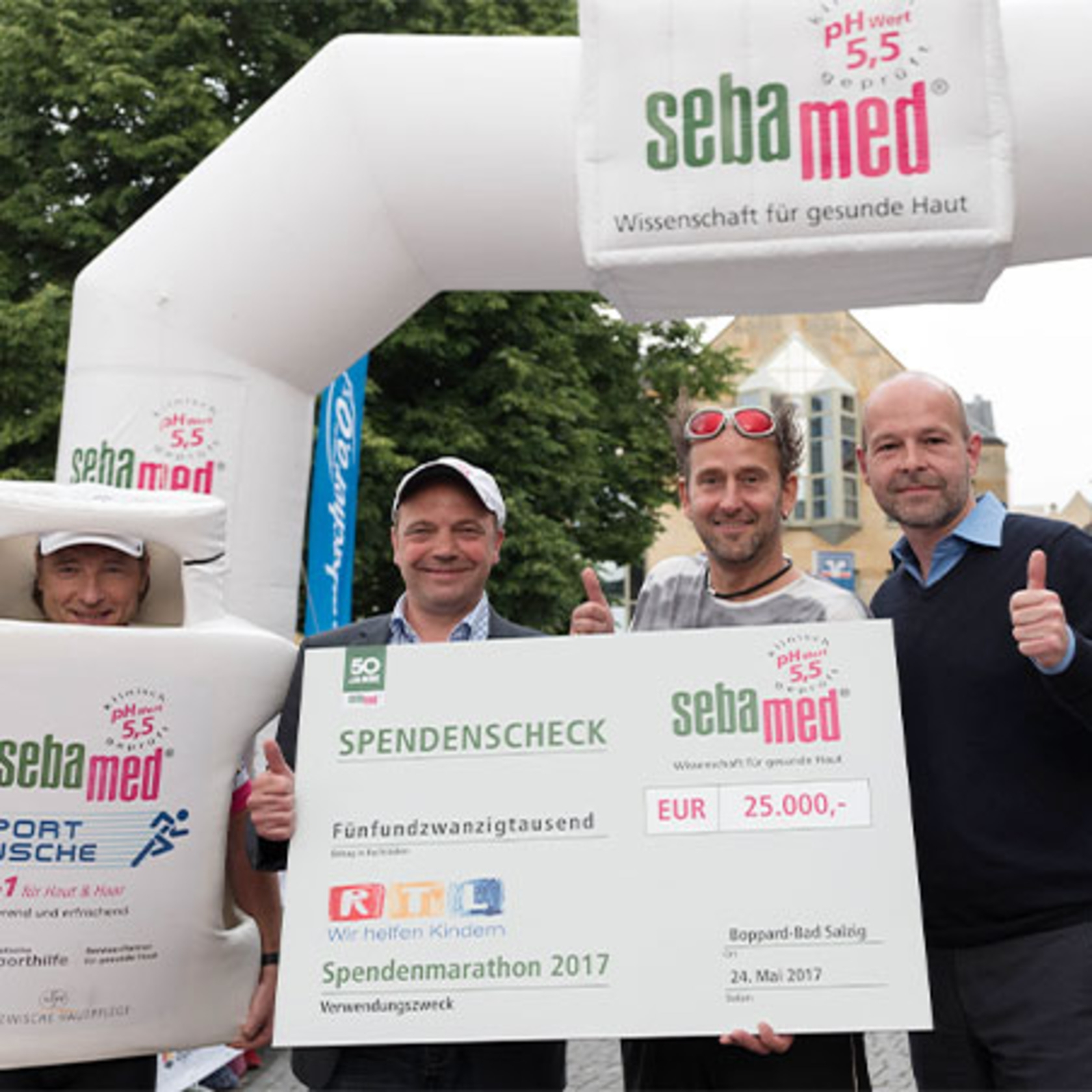 Sebamed donation marathon: check presentation with donation check and people