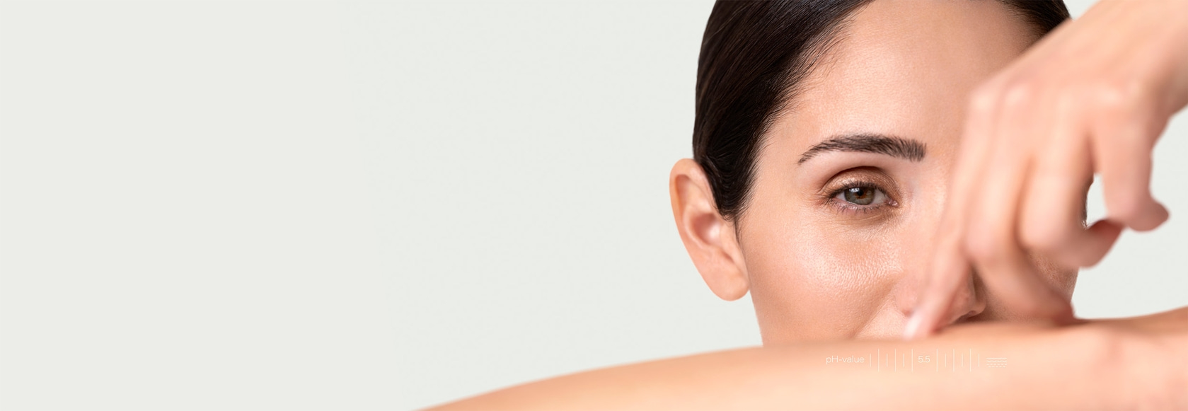 Close-up of a woman touching her skin, with pH value information.