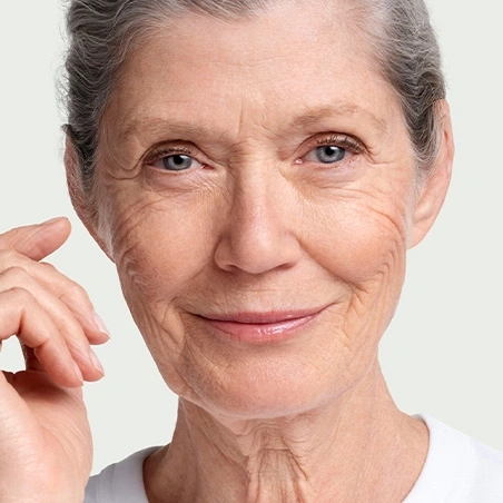 Portrait of an older woman with gray hair smiling