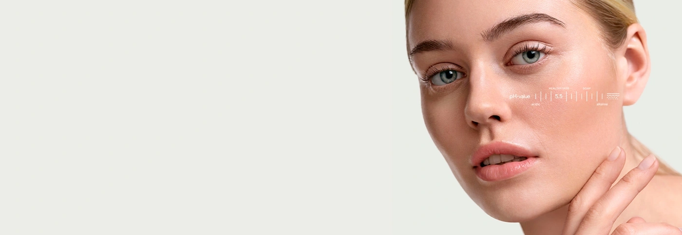 Close-up of a woman with a pH scale on her cheek.