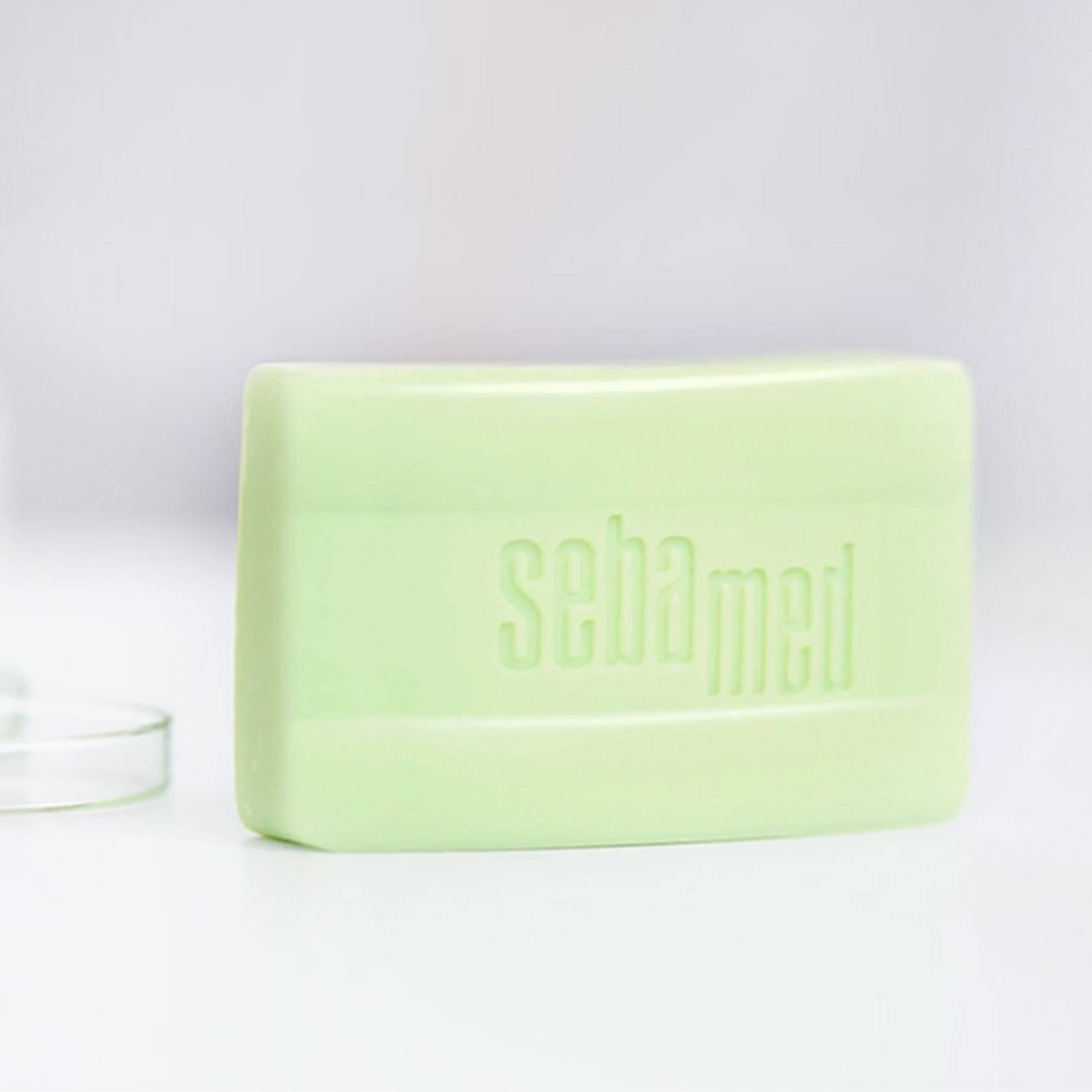 A green bar of soap with the word 'sebamed' on it.