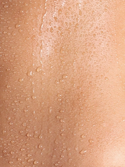 Skin with water droplets, wet and shiny, close-up, texture detail