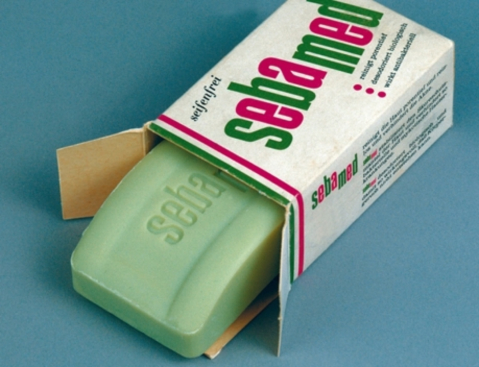 Sebamed soap in packaging, green, open, on a blue background